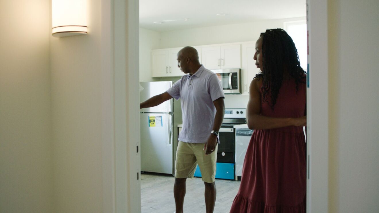 Couple examining kitchen in new apartment or home
