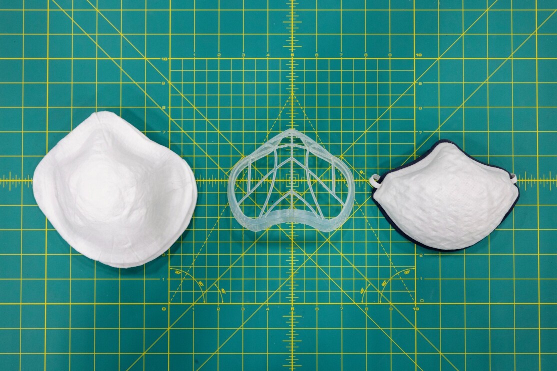 A prototype of a mask in three pieces on top of graphing paper.