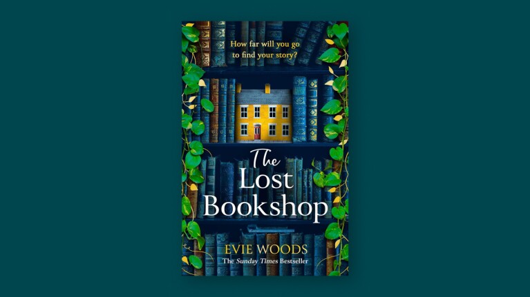 Book cover: The Lost Bookshop by Evie Woods, depicting miniature yellow house amid blue book spines