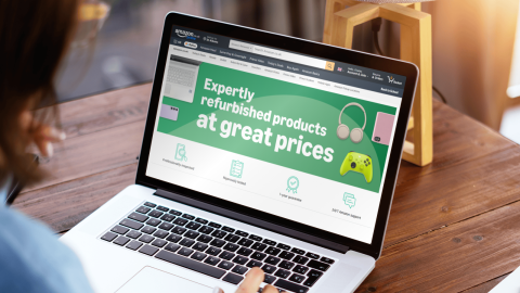 Woman on laptop with Amazon Renewed offering on screen