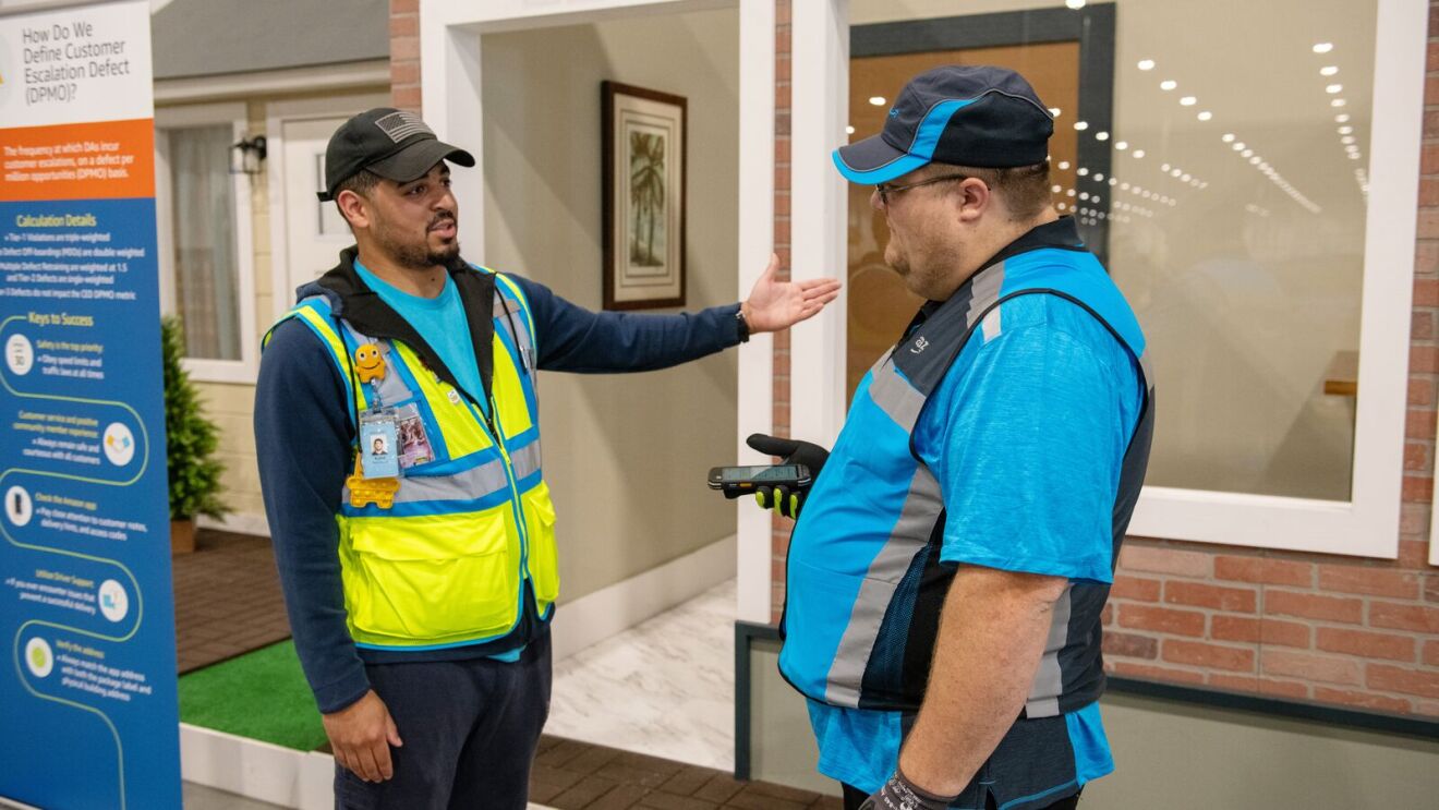 Amazon delivery trainer discusses proper delivery techniques with a new driver.