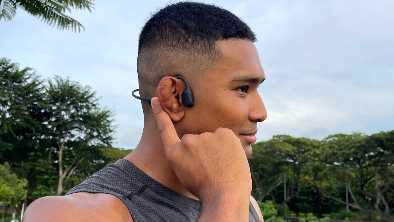 MMA fighter Amir Khan wearing Shokz headphones.