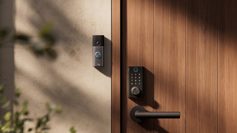 Ring Smart Lock on a door, with a Ring doorbell placed on the wall next to it.