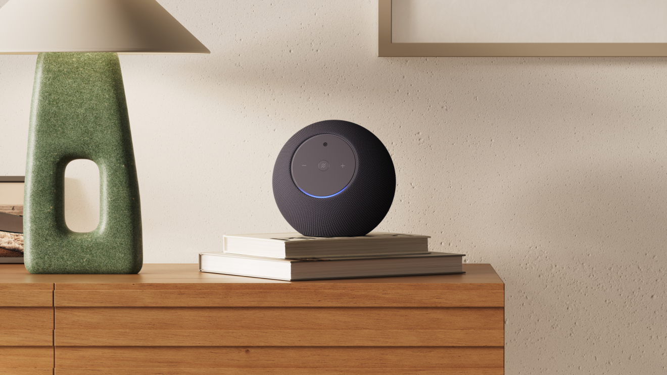 An Echo Studio placed on top of two books placed on a dresser.