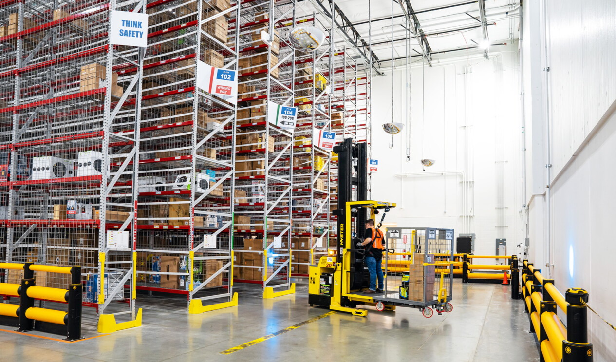 An Amazon employee uses a machine to move packages in the SCA5 fulfillment center.