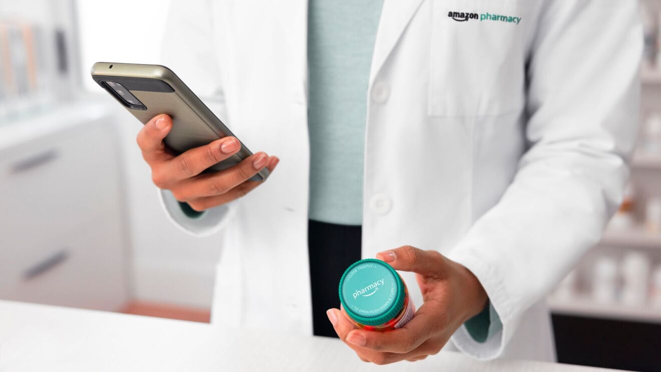 Close-up of pharmacist's hands holding tablet and medication