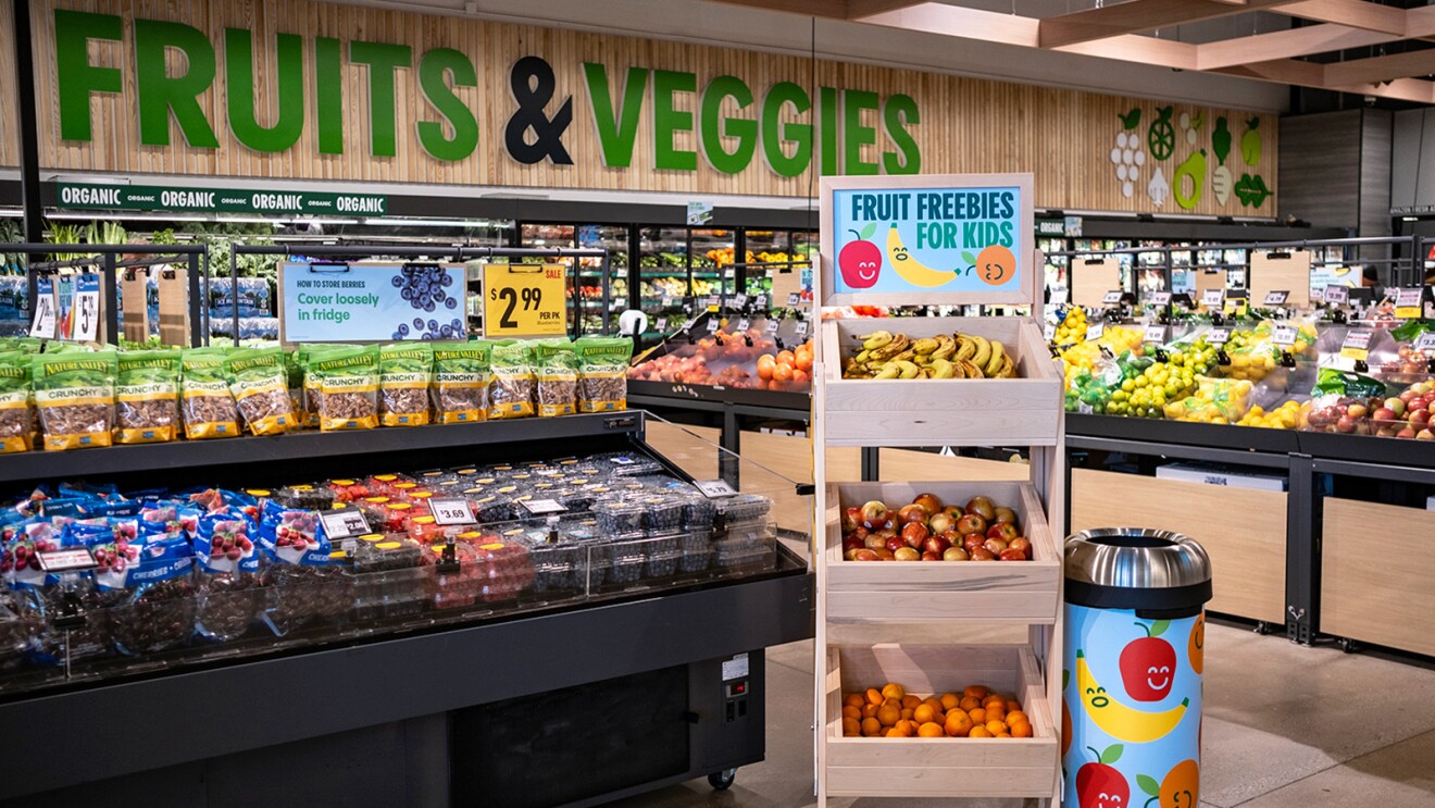 A photo of fruit in a fruit stand for kids inside an Amazon Fresh store.