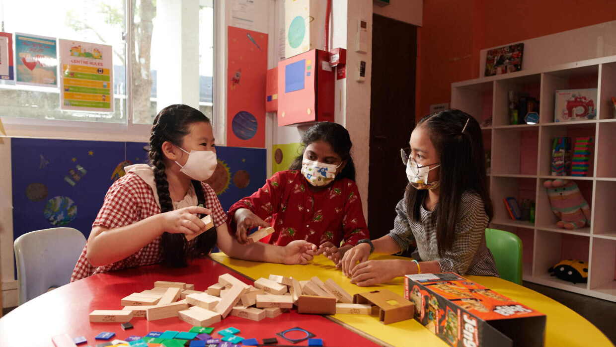 Three young children playing with toys that have been donated to NPOs as part of Amazon.sg's Delivering Smiles campaign