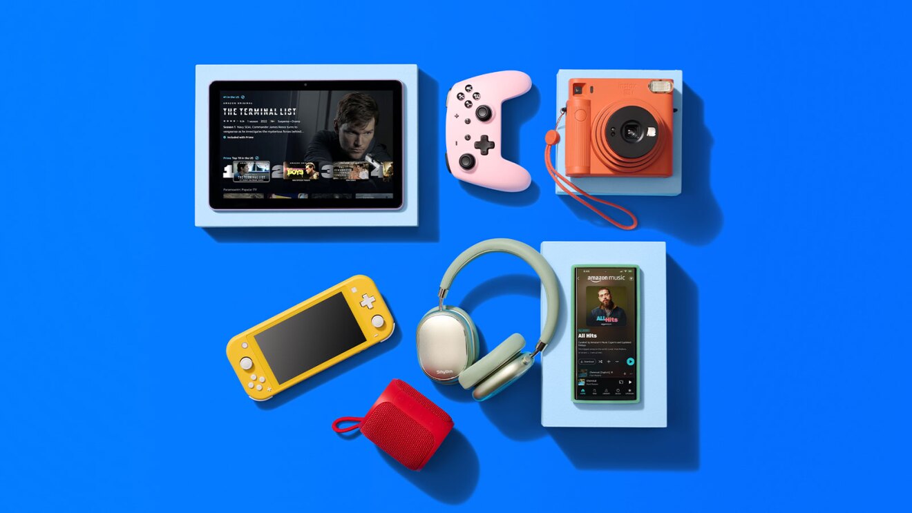 Modern tech gadgets arranged on vibrant blue background