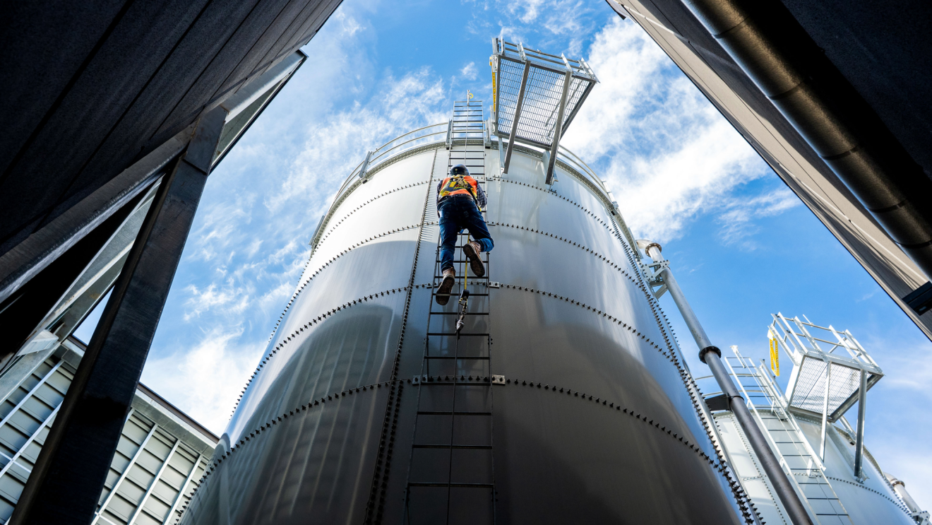 An employee climbing a water tower