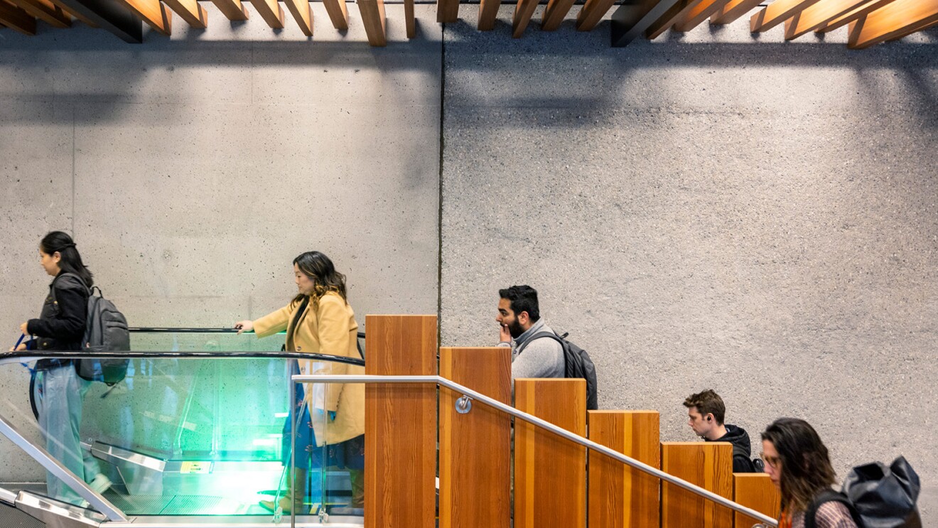 Amazon employees head up the escalator in the Seattle office.