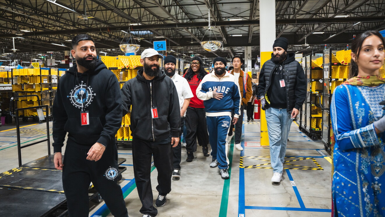 Nattam walking through an Amazon warehouse 