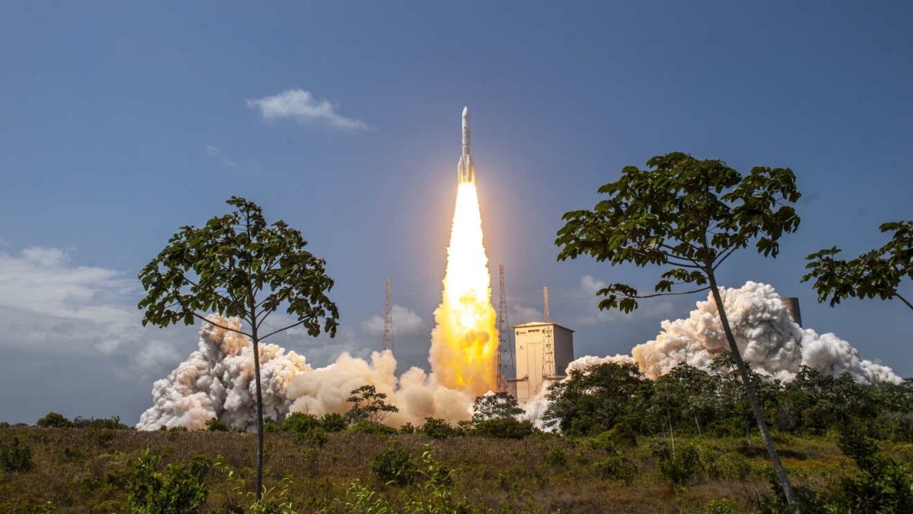 Space launch for Amazon Leo with brilliant flames amid lush vegetation