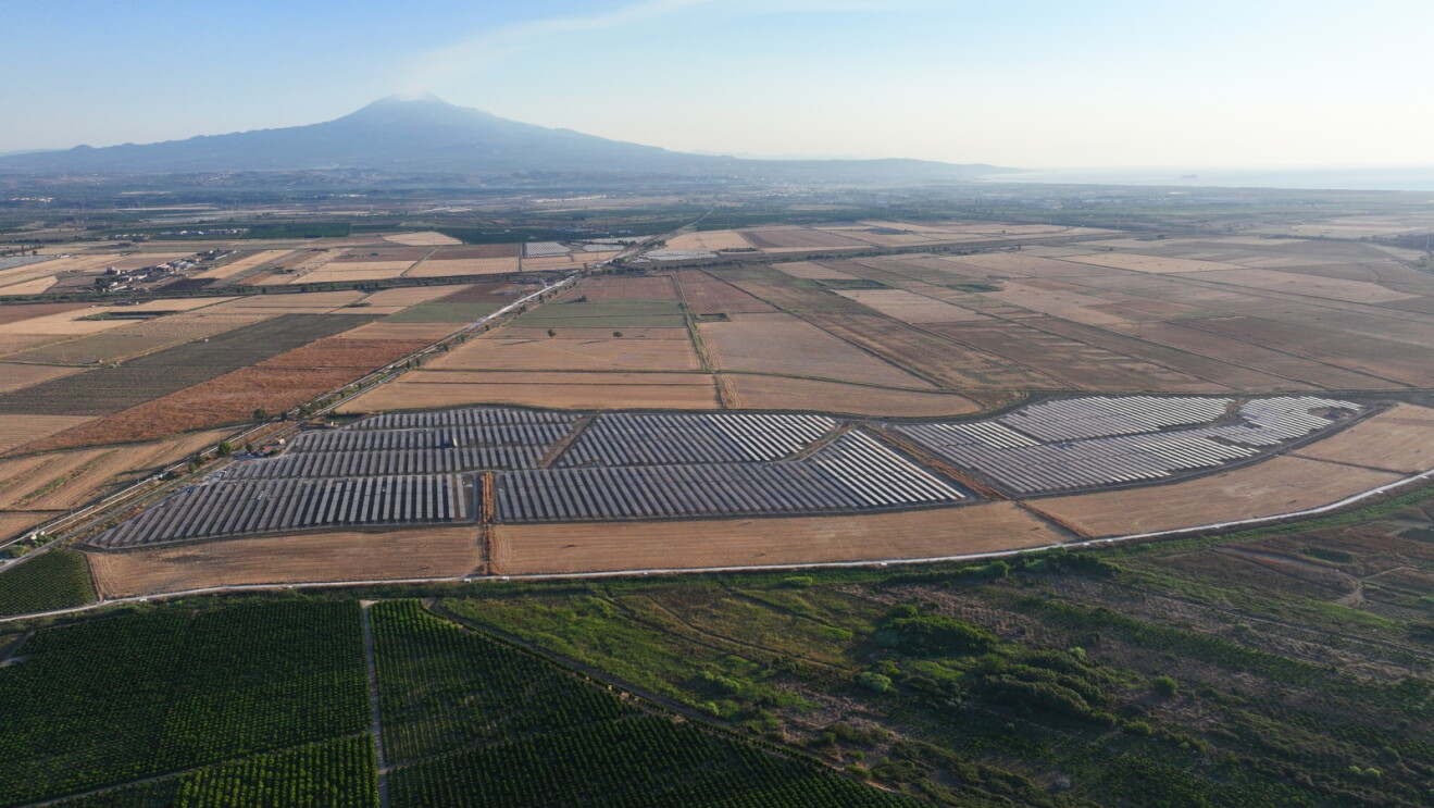 Aerial view of a solar energy farm set among farmland in Italy