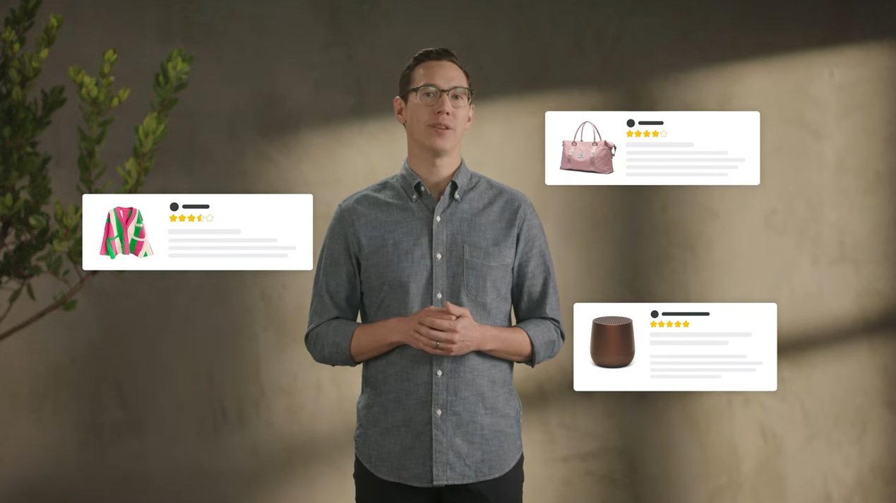 A man wearing a collared grey button up shirt stands up with three pop outs of Amazon products around him.