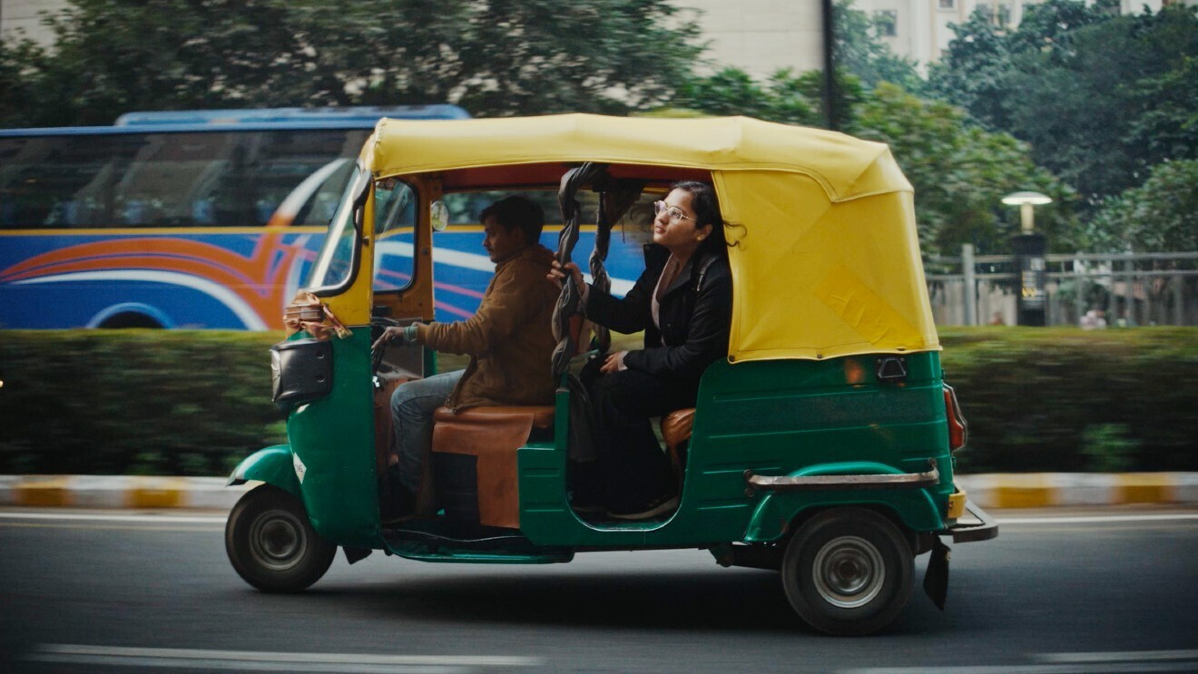 A photo of Vani Agarwal riding in the back passenger seat of a vehicle.