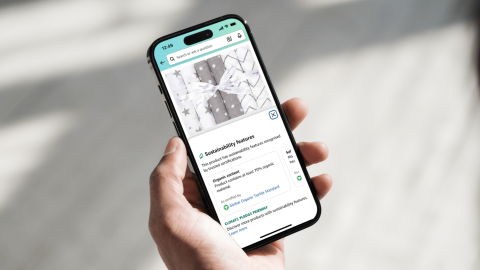 A phone displaying the Amazon app while someone shops for a Climate Pledge Friendly product
