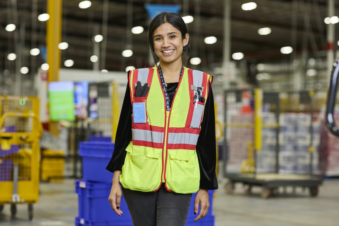 Area Manager Paaromita Chakravarty stands in fulfilment centre smiling