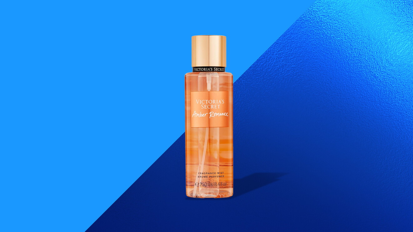 Victoria's Secret Amber Romance fragrance bottle against blue backdrop