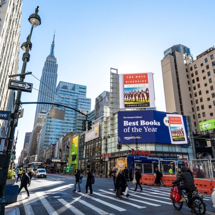 Busy Manhattan intersection featuring Amazon's Best Books billboard