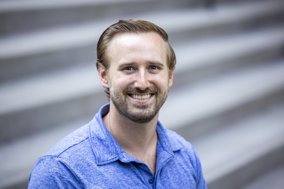 A bearded man in a blue shirt.