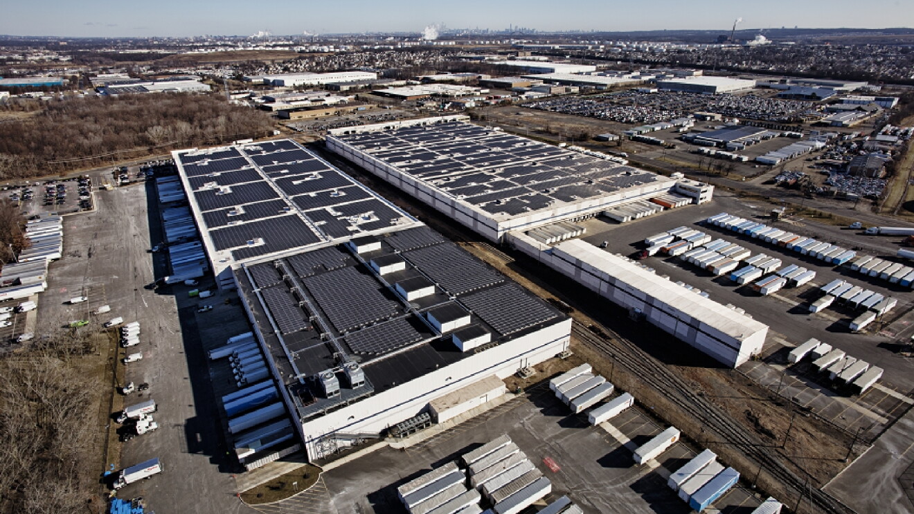 Solar panels on top of a large building. 