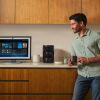 Man in kitchen drinking a coffee and talking to Alexa+