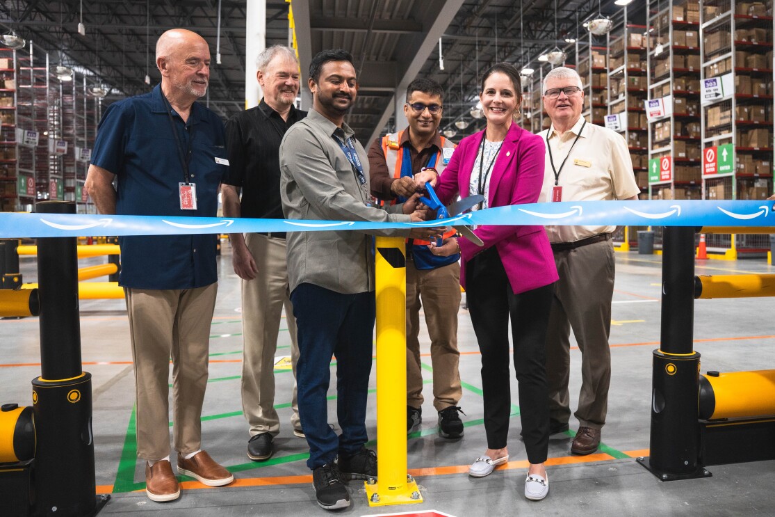 Amazon employees cutting ribbon