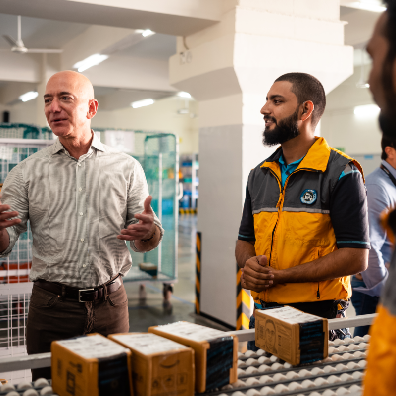 Jeff Bezos talks to employees at a fulfillment center