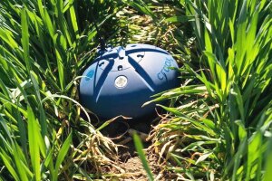 A photo of a CropX soil sensor in a bed of grass.