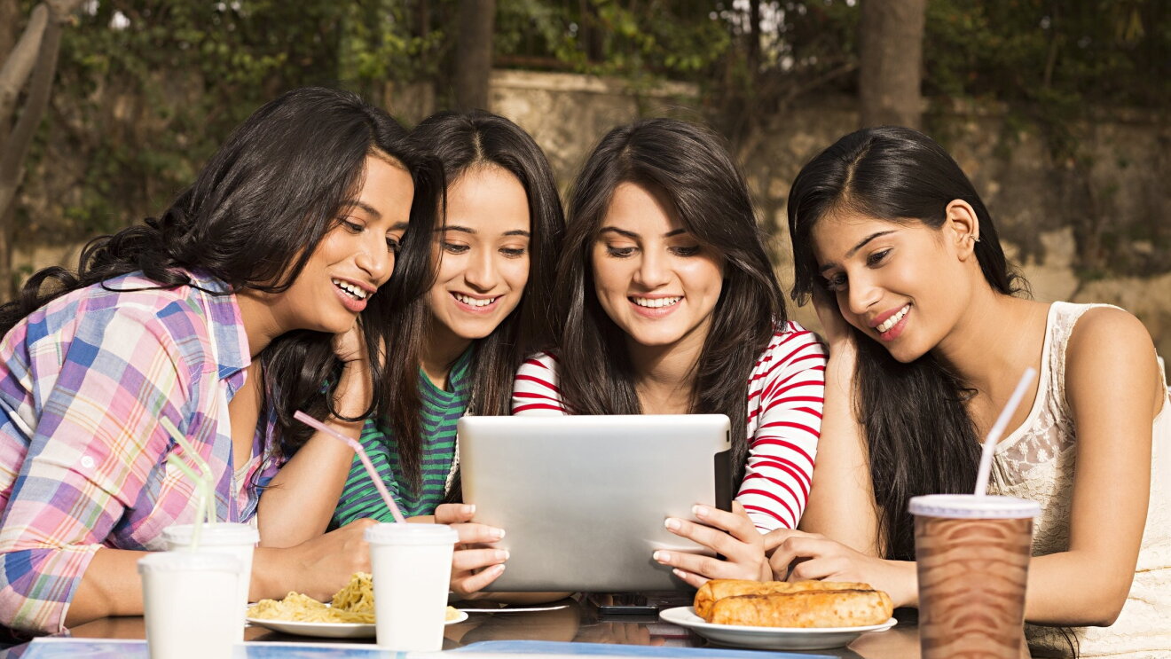 Youngsters watching a digital screen portraying Digital India