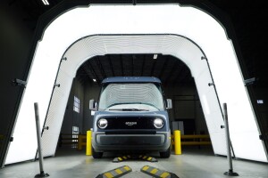 An image of an Amazon delivery van receiving a full-vehicle scan