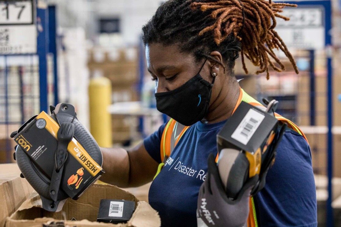 An Amazon employee readies product to be used for disaster relief.