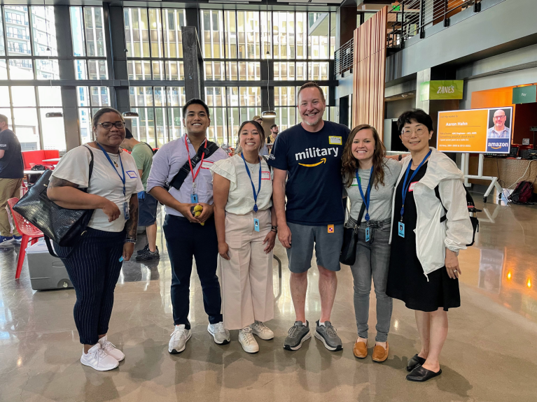 Nick Curry stands next to other Amazon employees at the office.