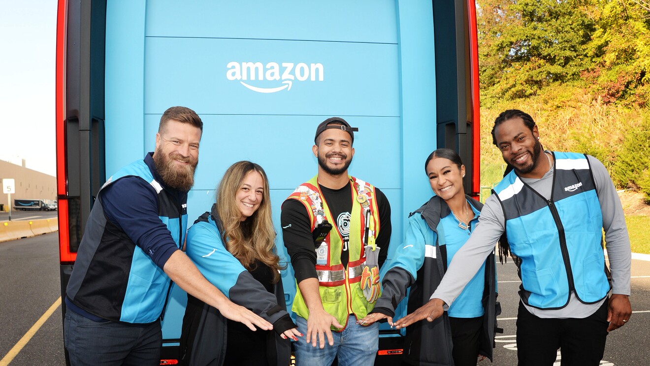 Football players Richard Sherman and Ryan Fitzpatrick driving Amazon’s electric delivery vans and delivering packages.