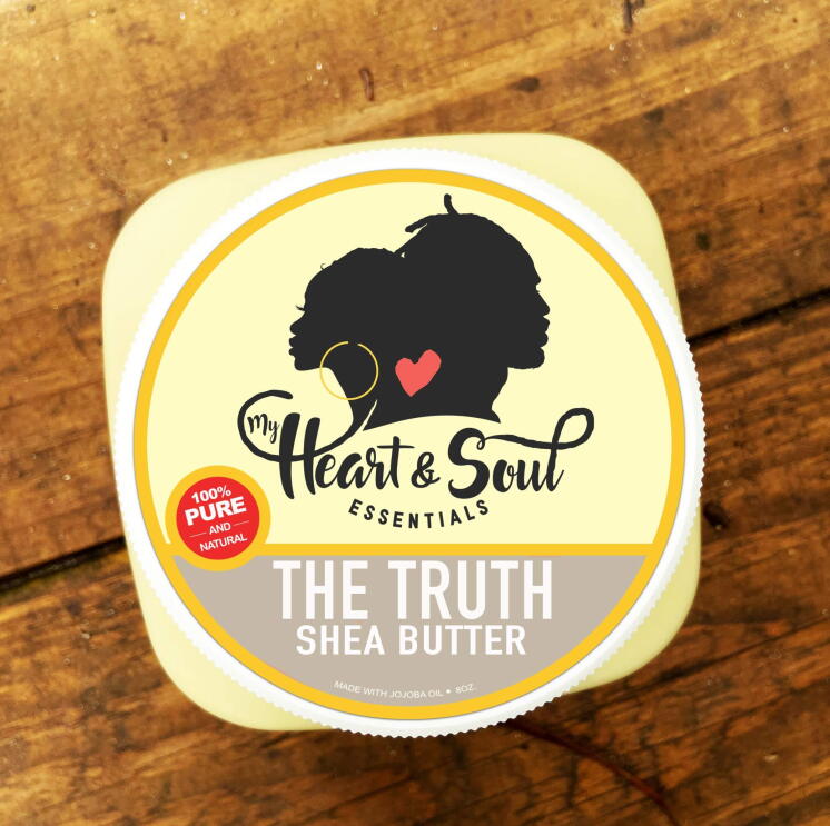 A top-down view of a shea butter product from My Heart and Soul Essentials sits on a wooden table.