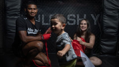 MMA fighter Amir Khan with his wife and child.