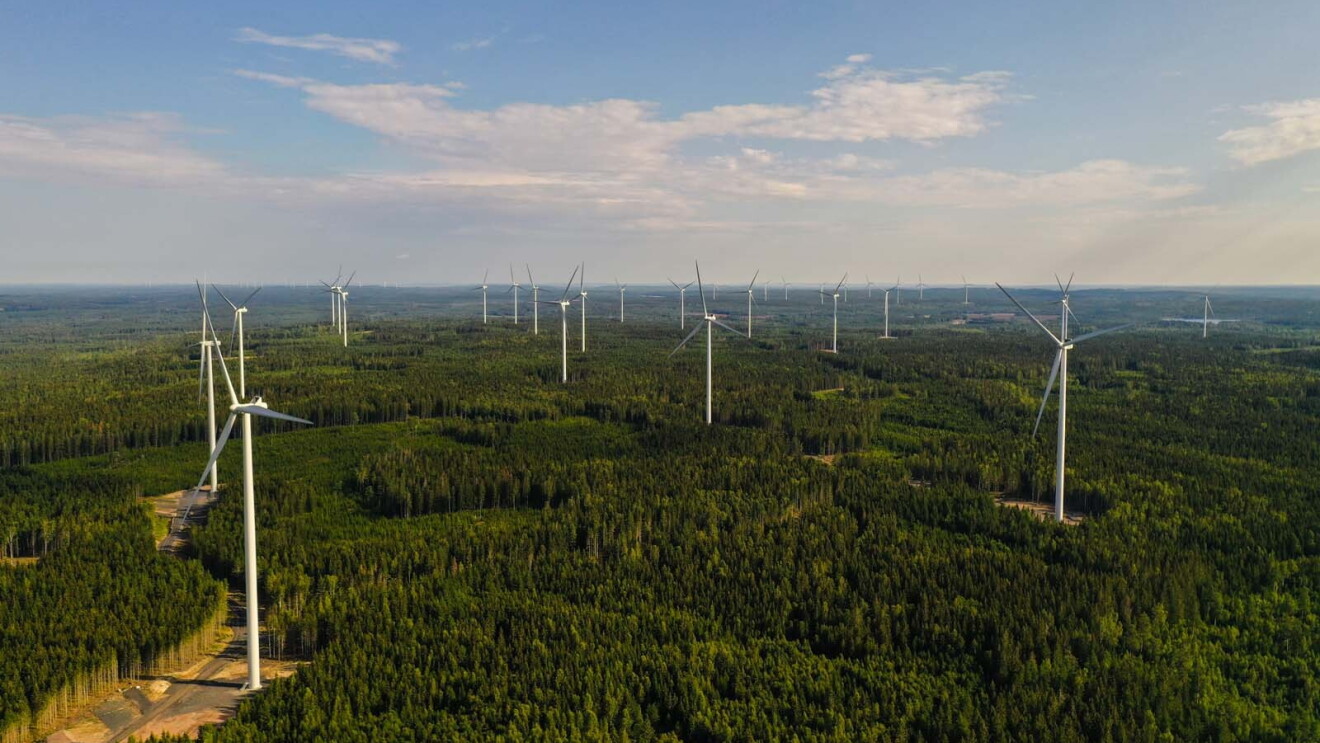 Aerial photo of wind farm turbines spread across the forest in Bäckhammar, Sweden.