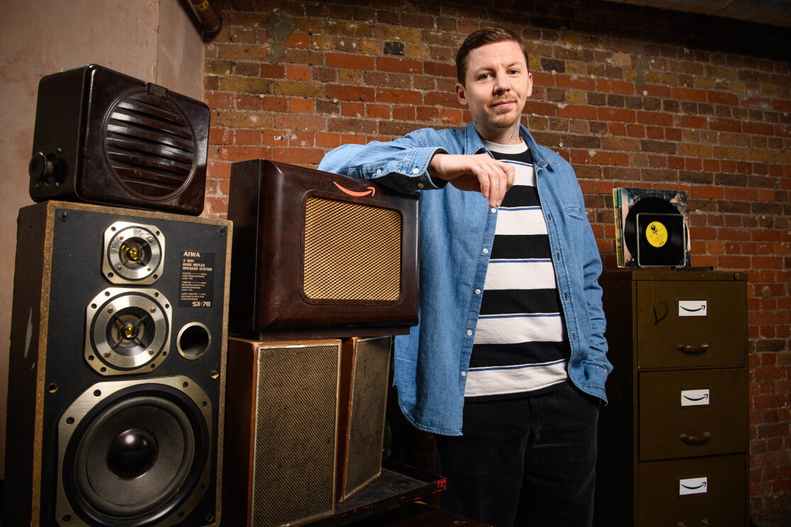 Rapper and mental health advocate, Professor Green, standing next to some vintage speakers. 