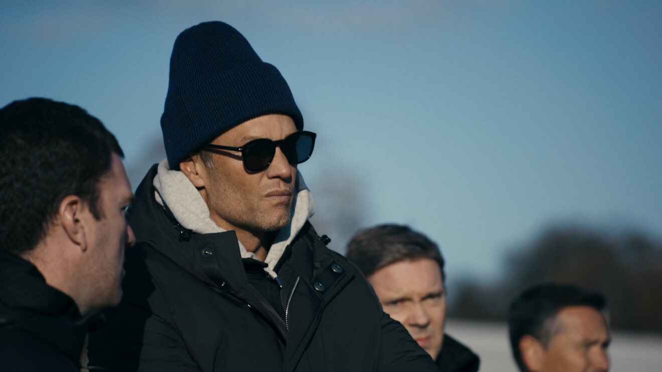 Tom Brady wearing dark winter clothes and shades