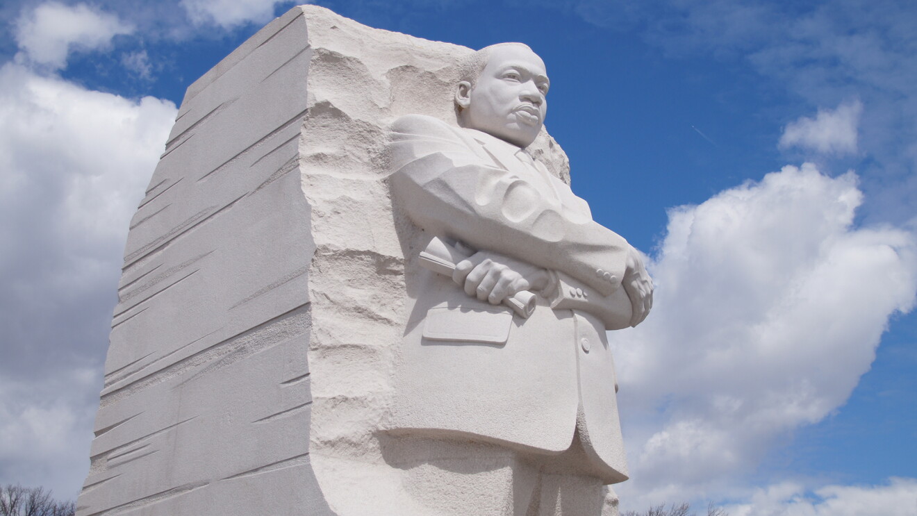 An image of the Martin Luther King Jr. monument with a blue sky and in the background. 
