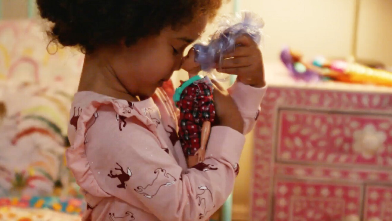 Prime Day 2023 live blog best deals: little girl holding a Barbie up to her face in her bedroom.
