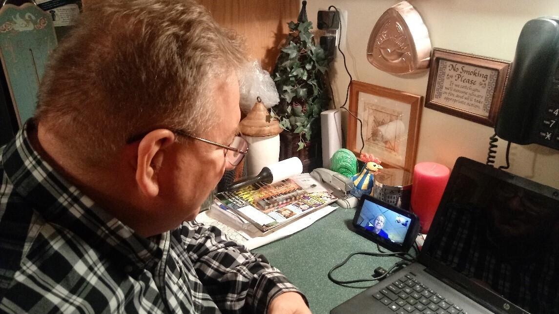 A man talks to his mom on an Echo Show device. 