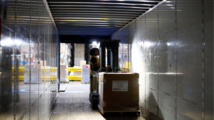 A volunteer helps pack donated supplies at an Amazon fulfillment center to support Hurricane Ian relief