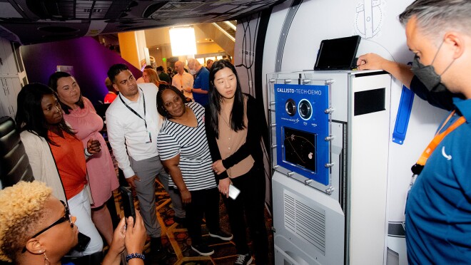 An image of the Teacher of the Year award winners checking out the mockup space shuttle at the re:MARS 2022 convention.