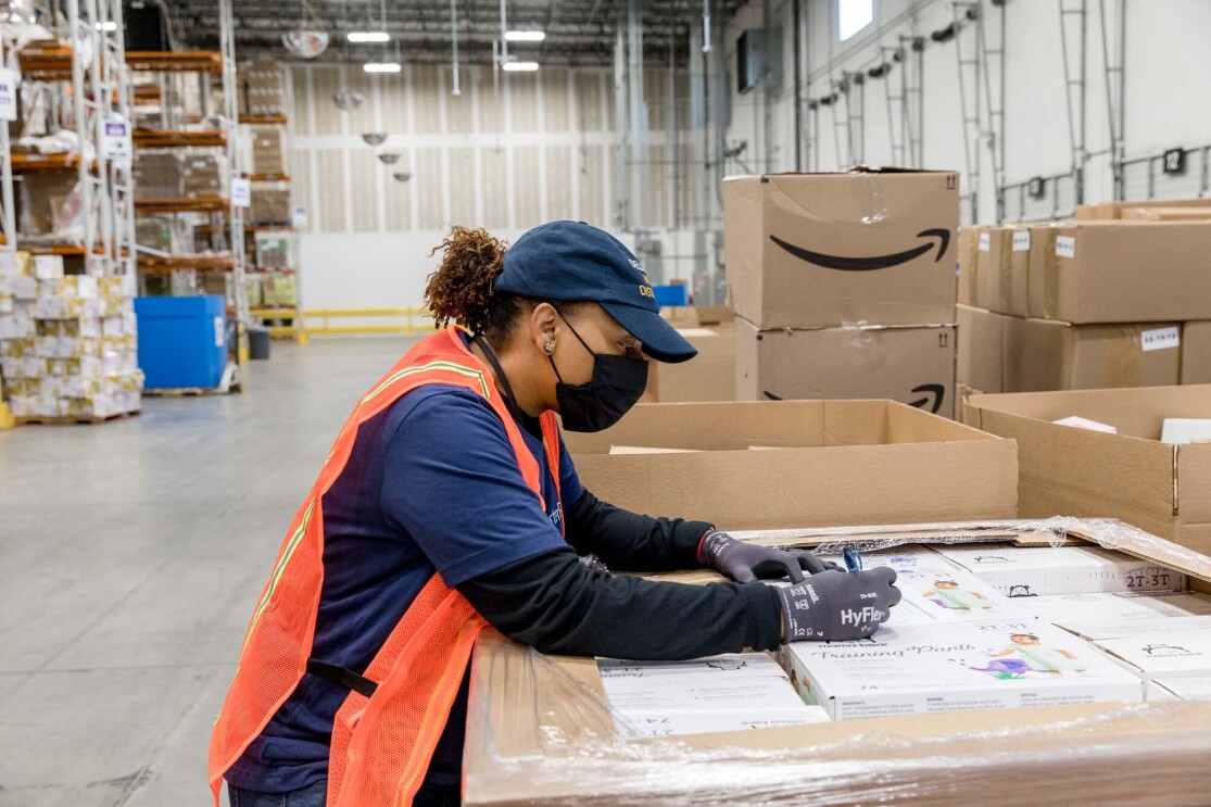 An Amazon employee readies product to be used for disaster relief.