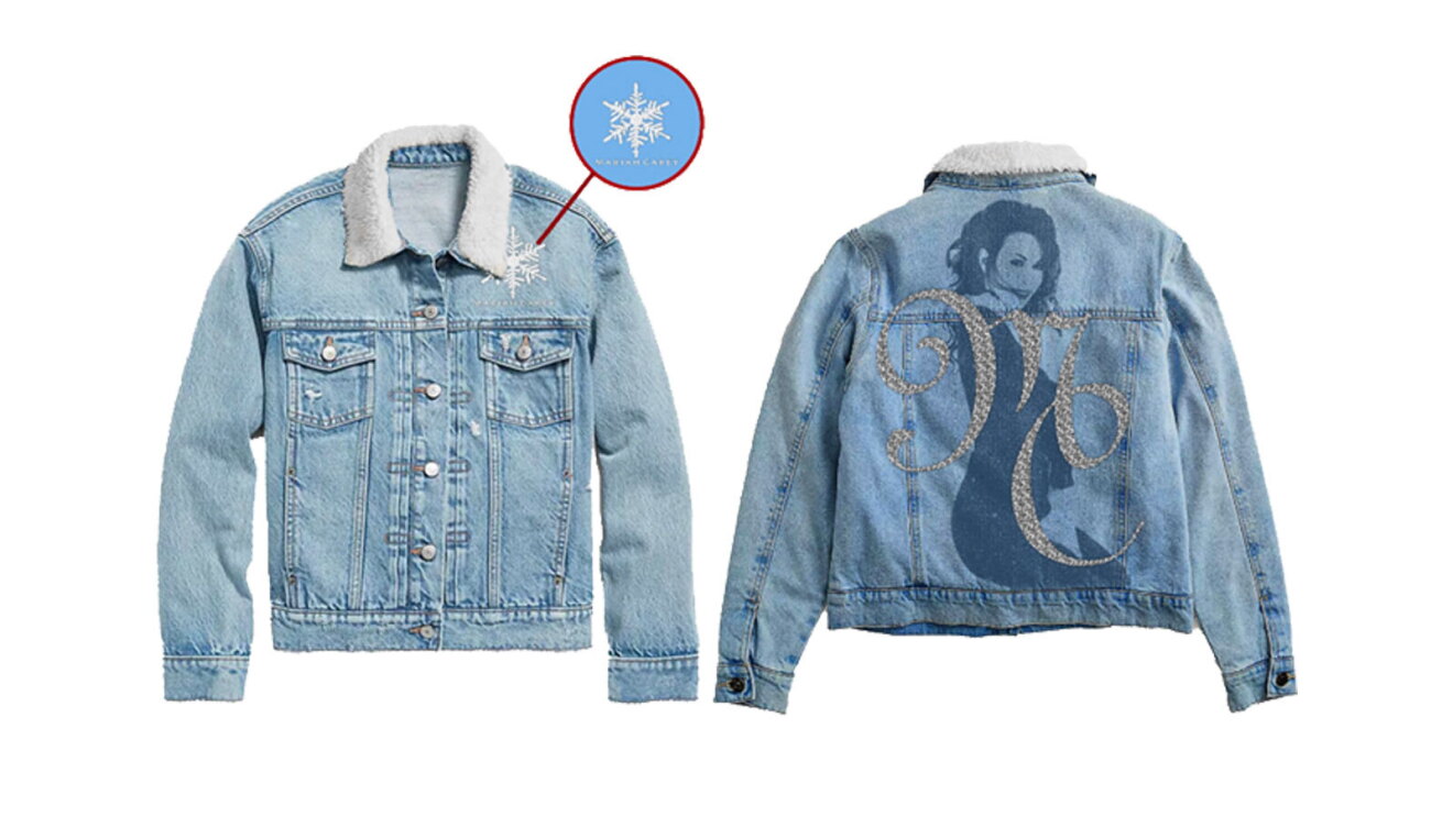 An image of a light-blue denim jacket with white trim on the collar. There are also rhinestones along the buttons. On the back, Mariah Carey's holiday image is impressed in dark blue, with gray lettering over top that says "MC"