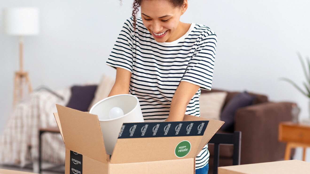 A woman unboxing an Amazon Resale delivery