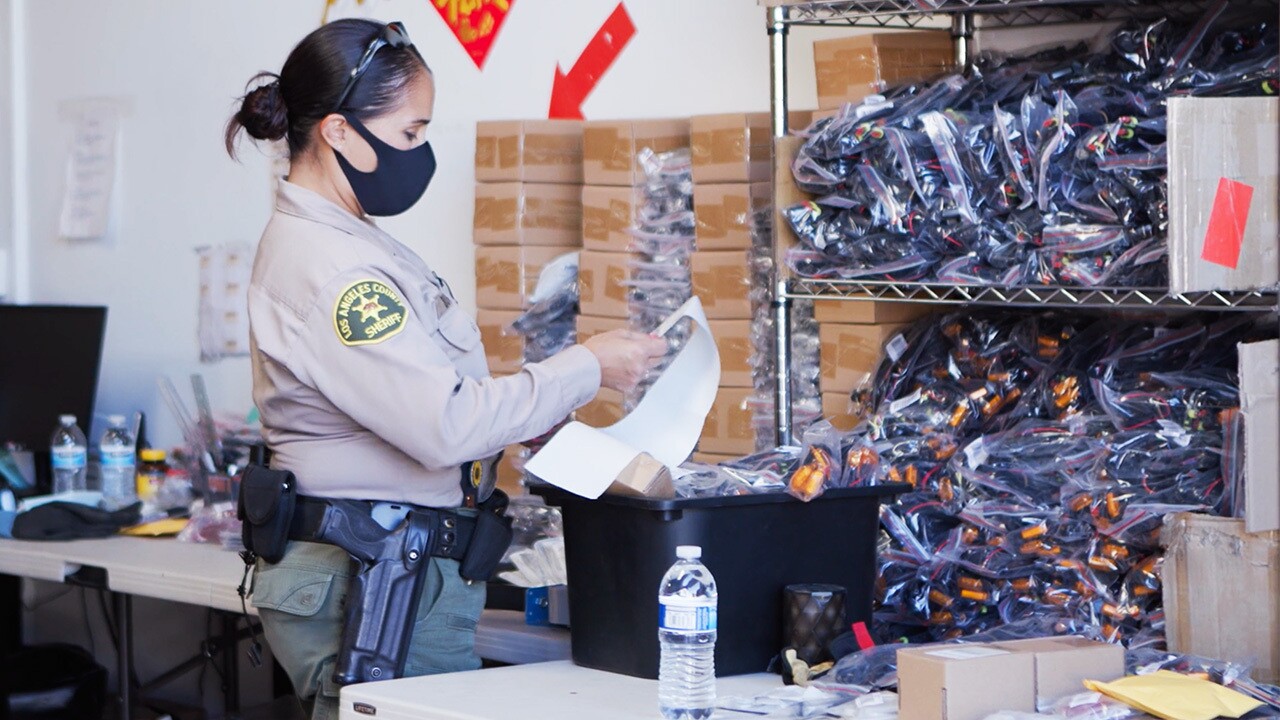 Police officers at the scene of where counterfeit items were found.