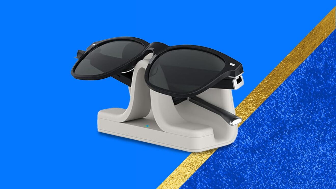 Sunglasses on white charging stand against blue background